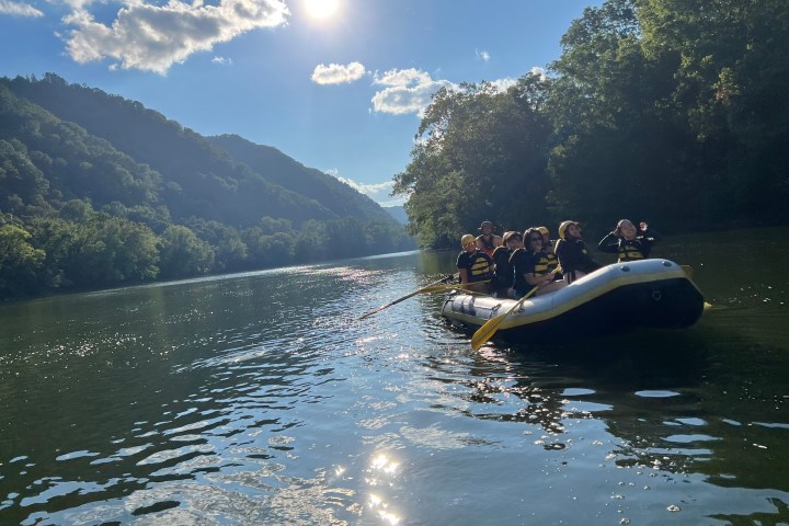 a small boat in a body of water with a mountain in the background