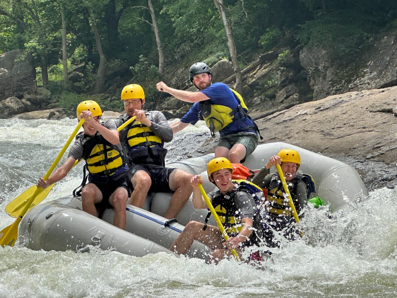 a group of people riding on a raft in the water