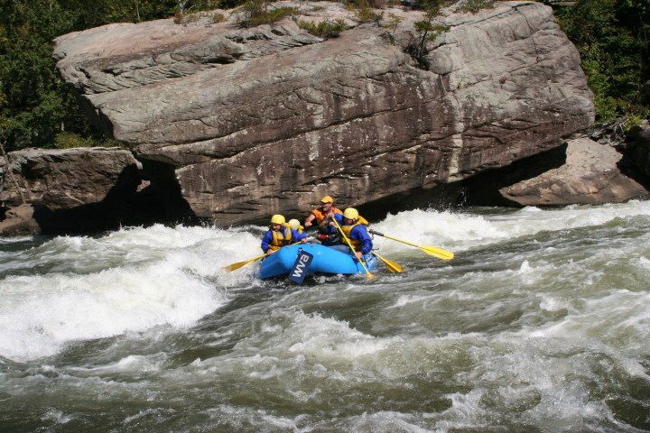 a man riding on a raft in a pool of water