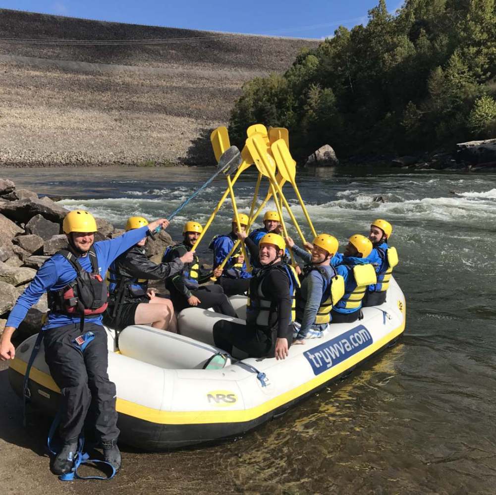 a group of people sitting on a raft