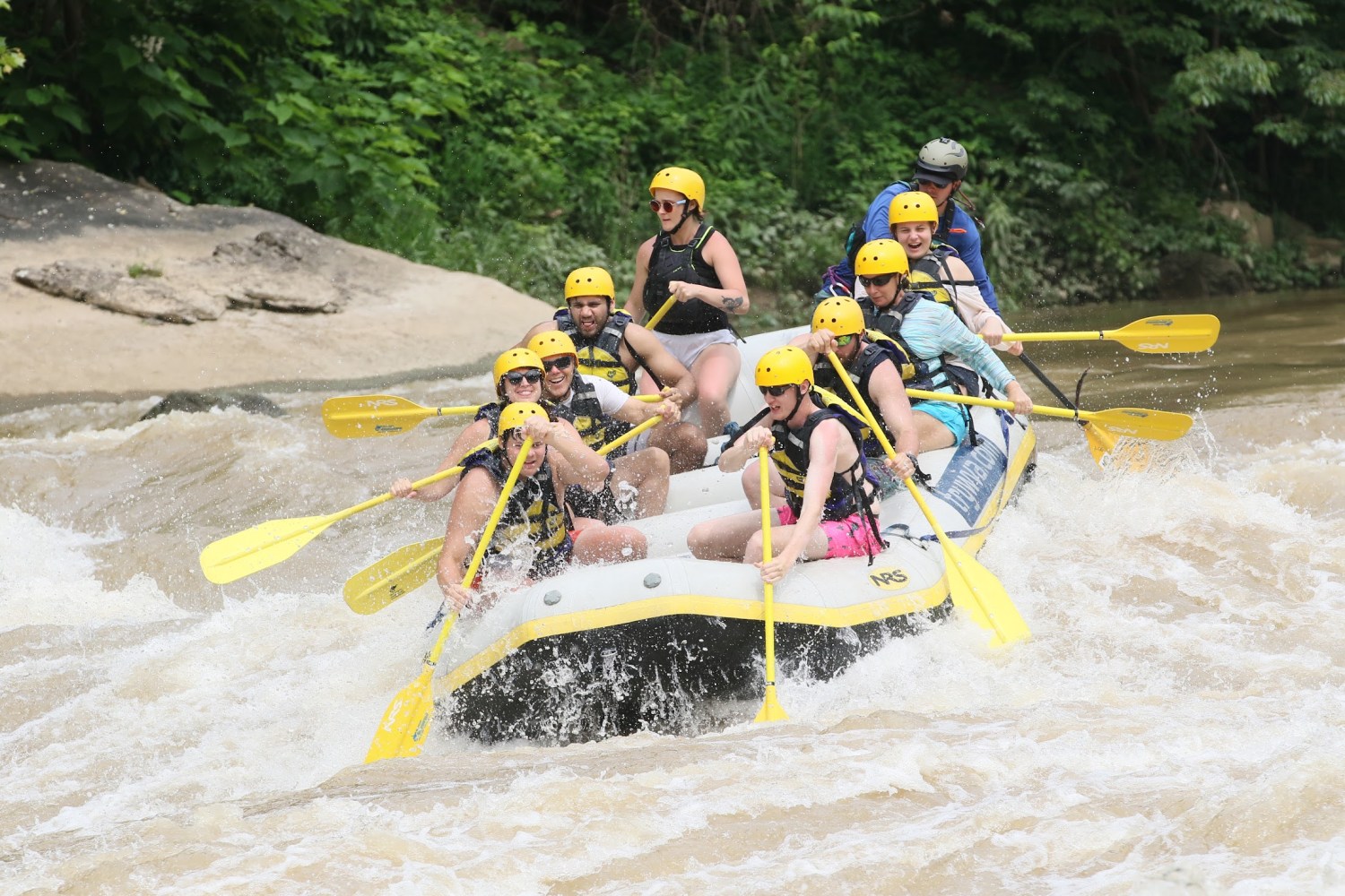 a man riding on the back of a raft